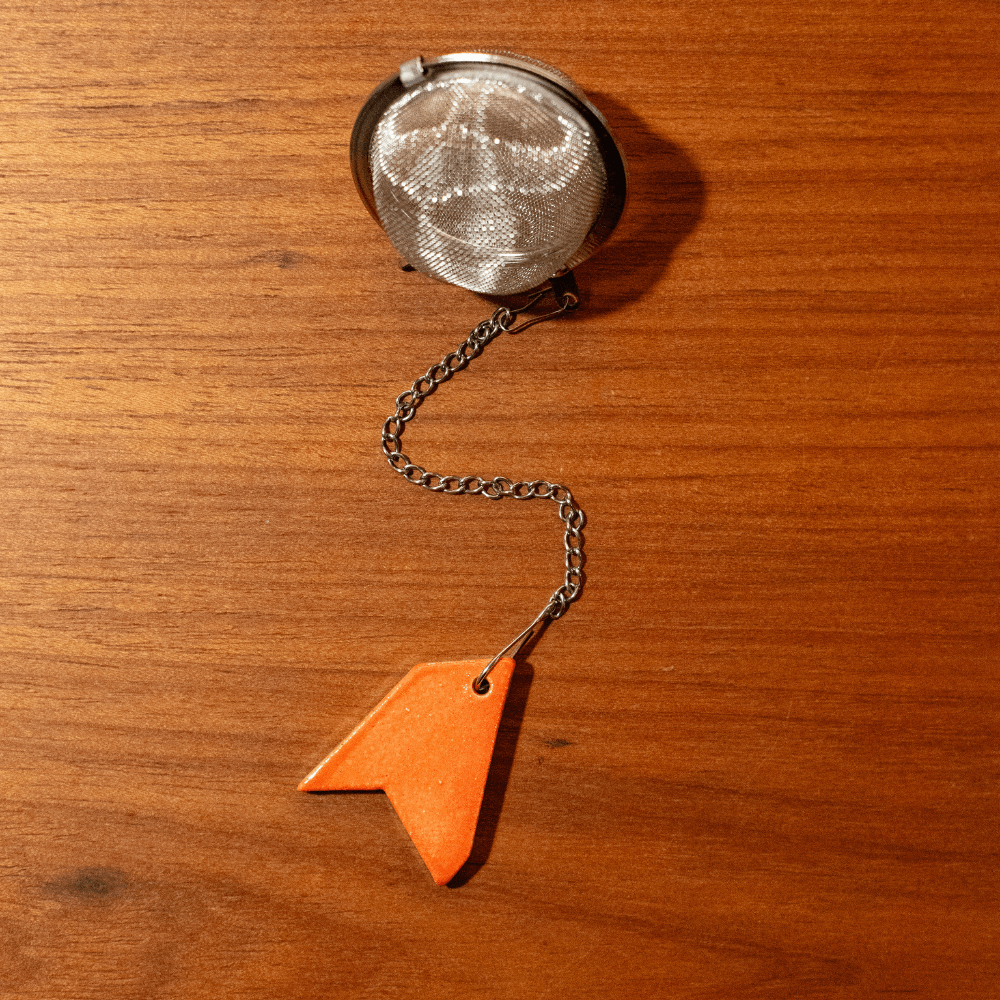 Infusor de Aco Inox Corrente Berloque Fragmentos Laranja